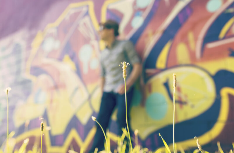 Leaning on Graffiti Wall Free Stock Photo