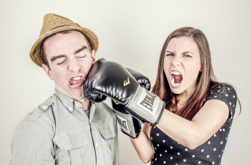 View Woman Punching a Man Free Stock Image